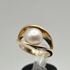 Vintage 14k Yellow Gold Pearl Ring Item w#275 This vintage 14k yellow gold ring showcases a beautiful 7.9mm genuine pearl at its center, offering a classic and timeless design. The warm yellow gold complements the lustrous pearl, creating a piece that's perfect for both everyday elegance and special occasions. Clean and in good condition, this ring is marked 14k and weighs 6 grams. A wonderful example of estate jewelry, it's ideal for collectors or as a thoughtful gift for her. Material: 14k Yel Formal White Bypass Ring, 14k Gold White Ring With Tension Setting, White 14k Gold Ring With Tension Setting, White 14k Oval Pearl Ring, 14k Gold Polished Pearl Ring For Anniversary, 14k Gold Pearl Ring With Polished Finish For Anniversary, White 14k Gold Hallmarked Rings, White Oval Pearl Ring In 14k Gold, White Open Band Ring For Formal Occasions