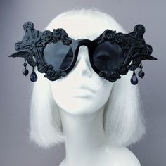 Hand-decorated black filigree ornate sunglasses. Decorated with hand moulded filigree, crosses & angel wings. They are UV400. With detailing on the arms. Dripping with black jewels. You can get these sunglasses in different coloured filigree! Currently my list is: Black White Red Silver (£5 extra) Gold (£5 extra) Yellow Orange Green Pink Pastel Pink Blue Pastel Blue HOWEVER most of my sunglasses base is red, white or black at this time. Just message me at the checkout to ask if i can change Black Glass Sunglasses For Festival, Black Sunglasses With Gradient Lenses For Festival, Black Tinted Sunglasses For Festival, Vintage Black Sunglasses For Festival, Gothic Black Sunglasses For Party, Black Gothic Sunglasses For Party, Sunglasses Decorated, Dark Beauty Magazine, Black Mass