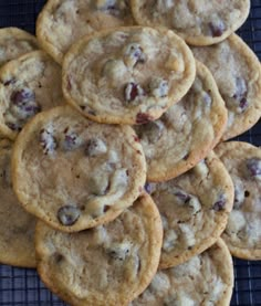 a pile of cookies sitting on top of a cooling rack