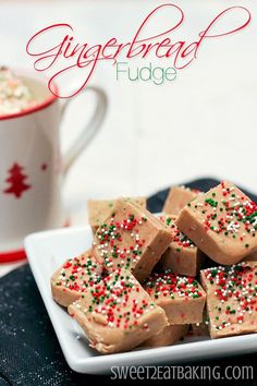 some brownies with sprinkles on a plate next to a coffee cup