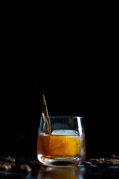 a glass filled with liquid sitting on top of a table