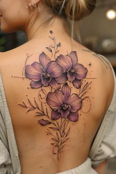 a woman's back with purple flowers on it