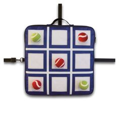 a piece of luggage with tennis balls and squares on the front, attached to a hook