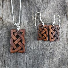 "This beautiful and unique hand-carved wooden Celtic knot jewelry set will be made for you, or a loved one, in my studio on the West of Ireland. These dainty rosewood Celtic necklace & earrings are recycled from musical instruments constructed by a local luthier. As a musician myself, I take enormous satisfaction in creating a jewelry set whose inherent wood has previously featured in a beautiful hand-made guitar. Also, part of rosewood's attractiveness is its durability and ability to stand Handmade Artisan Wood Jewelry, Artisan Handmade Wooden Jewelry, Handmade Wooden Pendant Jewelry, Traditional Handmade Wooden Jewelry, Artisan Wooden Jewelry As A Gift, Artisan Wood Jewelry Gift, Artisan Carved Brown Jewelry, Artisan Brown Carved Jewelry, Rustic Wooden Beads Jewelry As A Gift