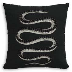 a black pillow with white snakes on it