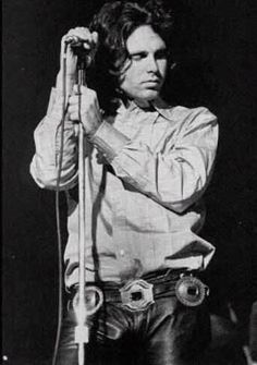 an old black and white photo of a man holding a microphone in his right hand