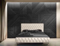 a modern bedroom with black and white wallpaper, an upholstered bed and pillows