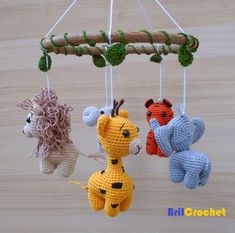 three crocheted stuffed animals hanging from strings