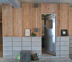 an empty room with wooden walls and metal doors