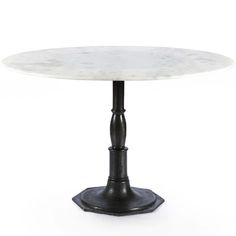 a white marble top table with black metal pedestals and an iron base, on a white background