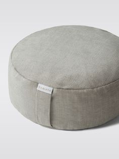 a round cushion with a tag on it