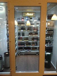 an open refrigerator filled with lots of beer bottles