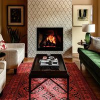 a living room filled with furniture and a fire place in the middle of the room