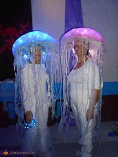 two women dressed in costumes made out of plastic wrap and led lights, standing next to each other with the caption diy costumes for women