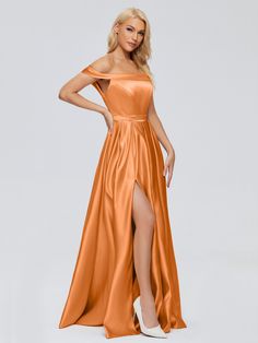 a woman wearing an orange dress with high slit