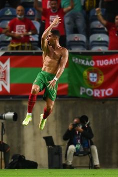 a shirtless soccer player jumping in the air