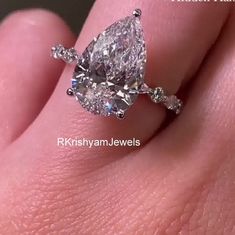 a woman's hand with a diamond ring on it