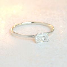 Our diamond ring in sterling silver is just right - bold yet simple enough for every day wear. It features a 6x4mm rectangle cubic zirconia diamond, prong set. This emerald cut rectangle cz diamond compliments any of our other stacking rings! Mix and match with an array of gemstone rings for a fresh, layered look. Find all our other birthstone stacking rings here: http://etsy.me/1MTC9gS {DETAILS}: * cubic zirconia diamond 6x4mm * 1.3mm band * sterling silver band & setting ►You might also ad Everyday Silver Solitaire Stackable Rings, Everyday Silver Stackable Solitaire Rings, Minimalist Silver Solitaire Stackable Rings, Classic Everyday Sterling Silver Birthstone Ring, Dainty Silver Stackable Rings With Single Diamond, Minimalist Silver Stackable Solitaire Rings, Silver Everyday Birthstone Ring With Bezel Setting, Silver Birthstone Ring With Bezel Setting For Everyday, Delicate Silver Stackable Rings With Single Diamond