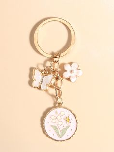 a keychain with a flower and butterfly charm on it's front end