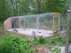 a chicken coop in the middle of a garden