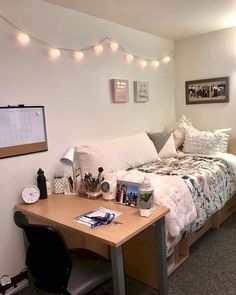 a bed room with a neatly made bed and desk