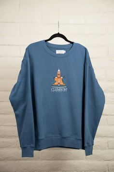 Show your school spirit in this super soft cotton-polyester blend sweatshirt. The tight, clean embroidery on the chest pops with the iconic campus building logo. The ribbed collar, cuffs, and hem add structure and style to this cozy crewneck top. Whether heading to an early morning class or late night game, this sweatshirt allows you to display your college pride in casual comfort. The durable fabric ensures this classic embroidered college sweatshirt will remain a staple in your rotation for years. Collegiate Tops With Embroidered Logo For College, Collegiate College Tops With Embroidered Logo, Collegiate Sweatshirt With Embroidered Graphics, Relaxed Fit Crew Sweatshirt For Campus, Collegiate Cotton Sweatshirt For Campus, University Logo Sweatshirt For Campus, University Logo Sweatshirt For College, Collegiate Cotton Sweatshirt With University Logo, Collegiate Sweatshirt With Embroidered Logo For Campus