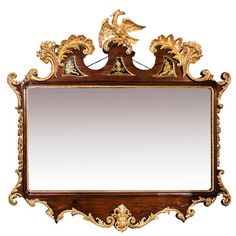 an ornate wooden mirror with gold decorations on it