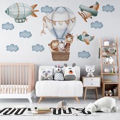 a baby's room with an airplane and hot air balloon wall decal