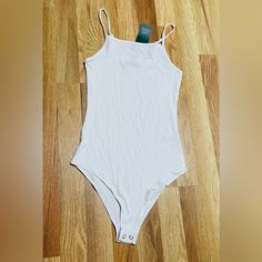 Square-Neck Bodysuit From Wild Fable. Sleeveless Design With Slender Straps And A Slim-Fit Silhouette. Made Of Cotton With Spandex For Comfortable Wear That Moves With You. Crotch Snaps Complete The Design For Easier Dressing. Summer Sleeveless Bodysuit With Adjustable Straps, White Spaghetti Straps Bodysuit For Summer, Summer Stretch Bodysuit With Spaghetti Straps, Casual Cami Bodysuit For Beach, Casual Fitted Bodysuit With Adjustable Straps, Casual Cami Bodysuit With Adjustable Straps, White Strapped Bodysuit For Summer, Casual Seamless Bodysuit With Tank Straps, Casual Seamless One-piece Bodysuit