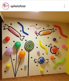 the wall is decorated with colorful candies and lollipops