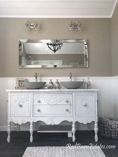 a bathroom with two sinks and a large mirror above the double sink vanity in front of it