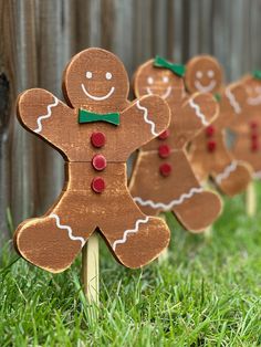 small wooden gingers are lined up in the grass