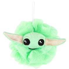 a green stuffed toy hanging from a string