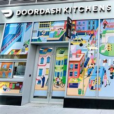 the front entrance to a store that has many windows and doors painted with cartoon characters