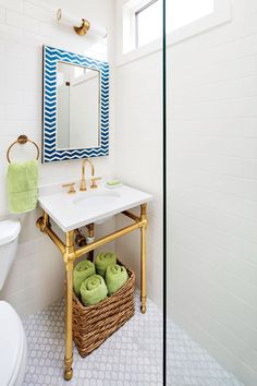 a bathroom with a sink, mirror and towel rack