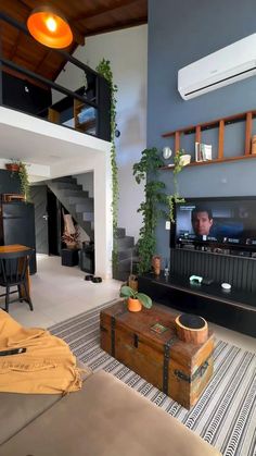 a living room filled with furniture and a flat screen tv on top of a wall