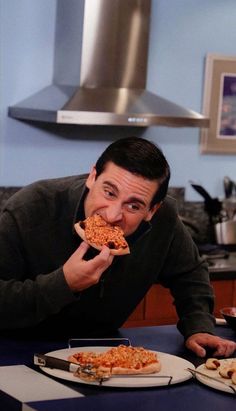 a man is eating a slice of pizza