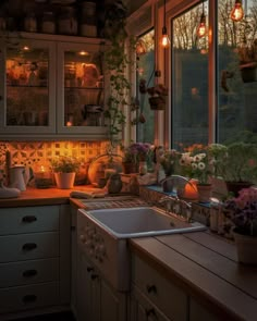 a kitchen filled with lots of pots and pans on top of a counter next to a window