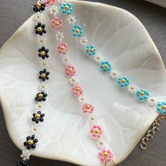 a white plate topped with two necklaces on top of it