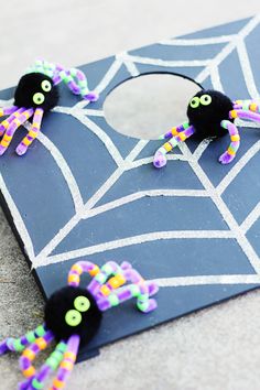 some black and purple spider decorations on a board