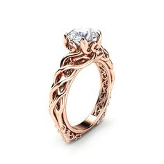 a rose gold engagement ring with an intricate design and a round diamond in the center