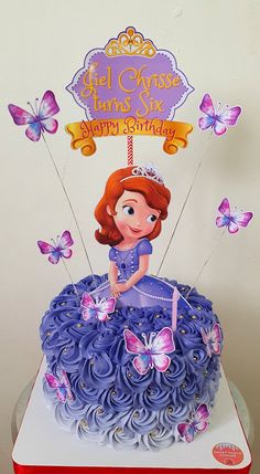 a birthday cake with a princess sitting on top of it