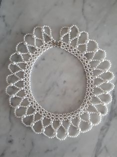 In good condition. For measurments see pictures. Silver Round Beaded Necklace Costume Jewelry, White Pearl Beaded Costume Necklaces, Netted Beaded Necklace, Adjustable Beaded Pearl Costume Necklace, White Round Beaded Costume Necklace, Pearl Outfits, Style Pearl Necklace, Pearl Outfit, Twenties Style