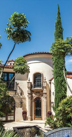 a large house surrounded by trees and plants