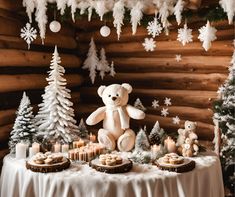 a teddy bear sitting on top of a table next to desserts and christmas trees