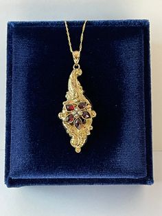 "Beautiful antique circa 1880s Victorian era 14k yellow gold genuine garnet and seed pearl flower brooch conversion pendant! This pendant contains five marquise cut genuine garnets with an estimated 0.7 ctw in a flower shape with four seed pearls in the center. It's shown modeled on a 14k yellow gold new 18\" chain. A wonderful piece of fine antique jewelry, that is ready to be worn! ERA - Circa 1880s - Victorian Era METAL / MATERIAL - 14k yellow gold,4 seed pearls, 5 genuine garnets ( approx. 0.7 ctw) MARKINGS / HISTORY - Both pendant and necklace stamped \"14k\"  CONDITION - Good antique condition. Yellow gold metal has been professionally polished & cleaned. Amazing antique conversion pendant necklace !  SIZE / MEASUREMENTS - Chain Modeled: 14k Yellow Gold 18 inches, Pendant: 2 x 3/4  i Victorian Hallmarked Jewelry For Opera, Victorian Baroque Formal Jewelry, Antique Pendant Jewelry For Opera, Victorian Pendant Jewelry For Opera, Heirloom Style Formal Necklace With Brooch, Victorian Baroque Yellow Gold Jewelry, Vintage Marquise Jewelry For Gifts, Vintage Marquise Jewelry Gift, Victorian Jewelry With Flower Pendant For Anniversary