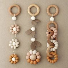 three wooden toys are arranged in the shape of flowers, leaves and circles on a gray background