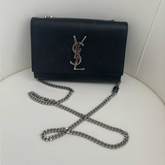 Authentic Ysl Black Handbag. With Silver Strap That Can Be Adjusted To Long Or Short. Gently Used. Not Too Bulky And Perfect For A Night Out! Original Price Point Was $1750, Asking $900, Shipping Included. Can Ship Within 24 Hours! Ysl Silver Bag, Silver Bag, Silver Bags, Yves Saint Laurent Bags, Black Handbag, Black Handbags, Yves Saint Laurent, Saint Laurent, Night Out