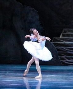 a ballerina in white tutu and ballet shoes