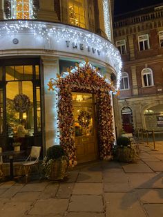 the entrance to a building decorated with christmas lights